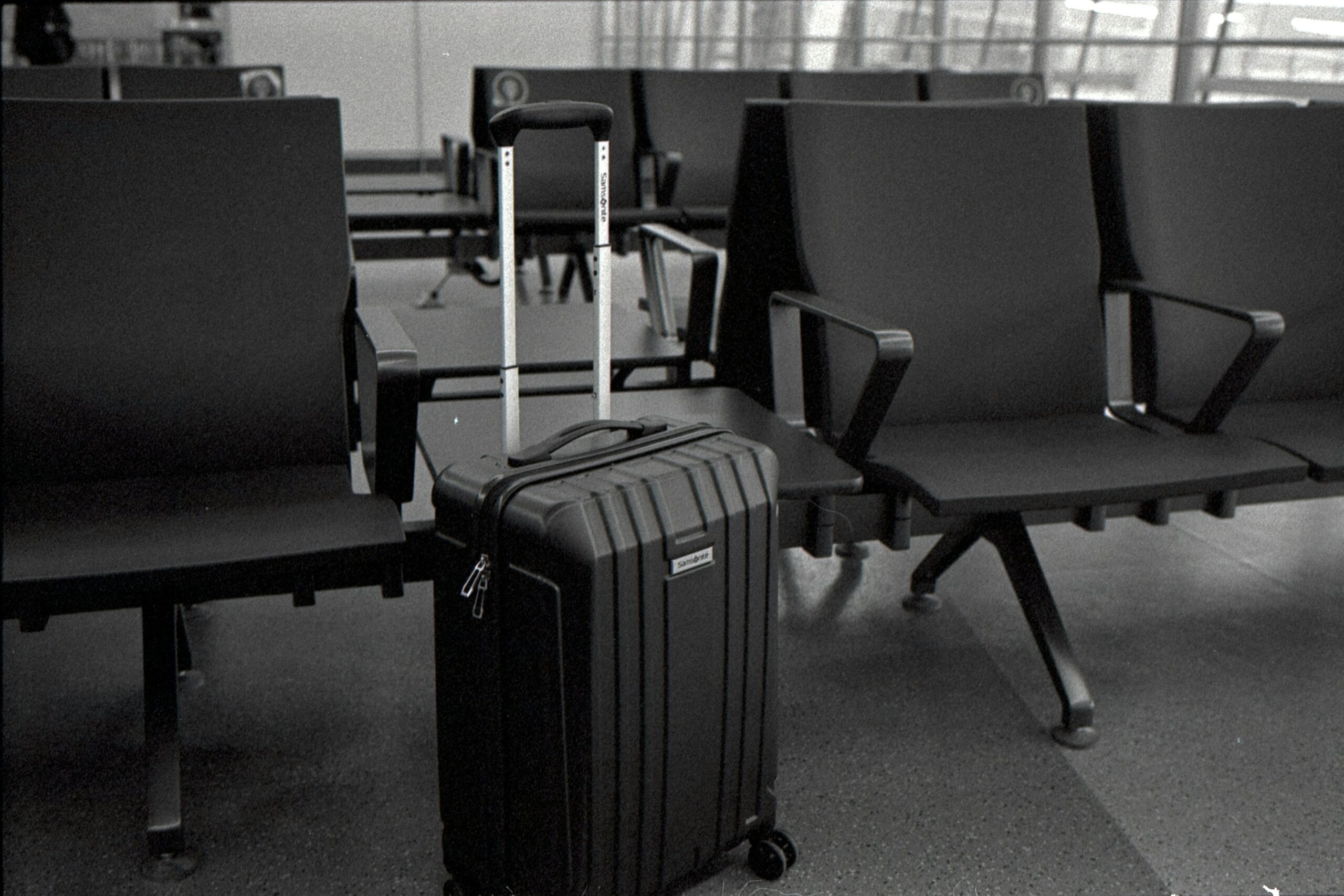 Photo of severely damaged suitcase at airport baggage claim