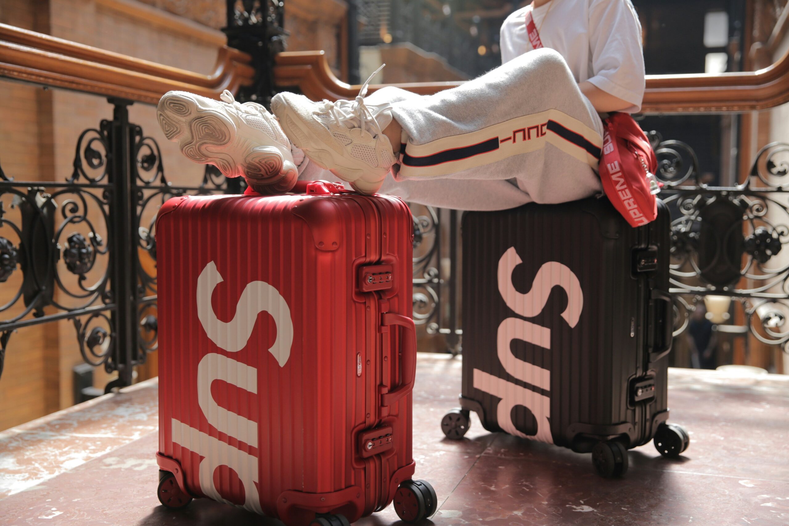A suitcase sitting alone on a conveyor belt surrounded by empty space representing lost luggage at the airport.