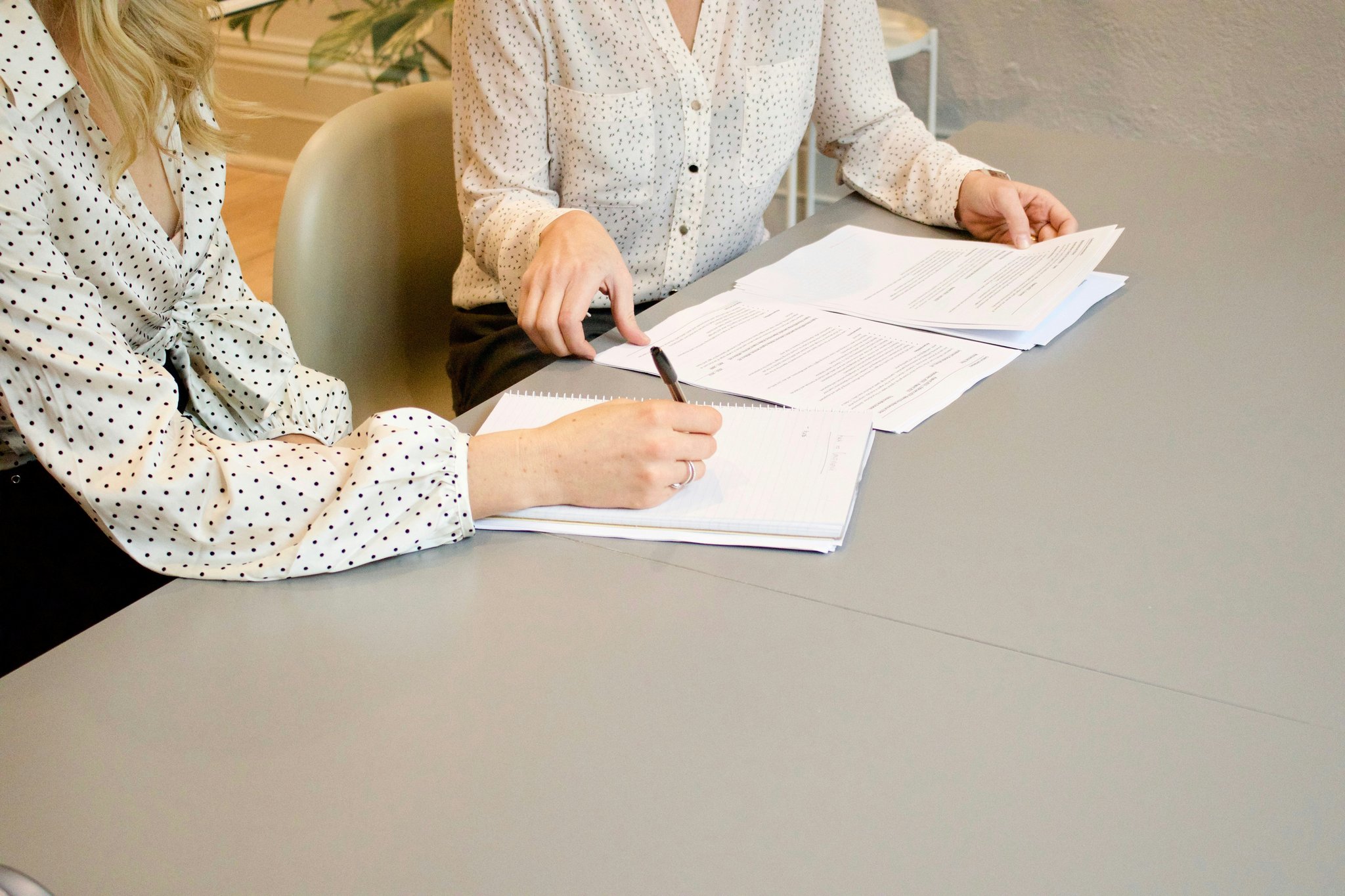 Closeup shot of someone reading small text on a policy document