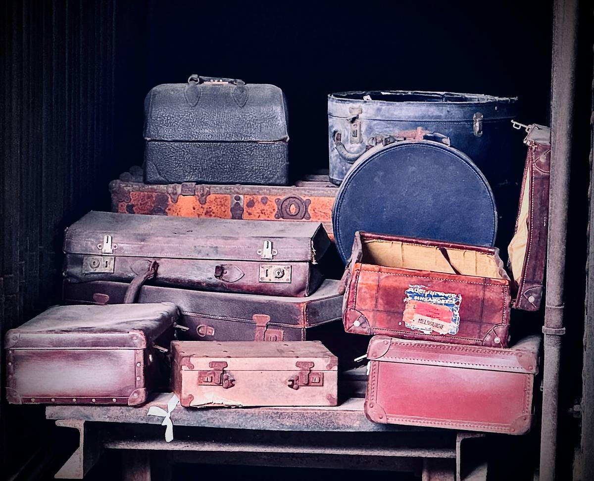 A crumpled suitcase on an airport conveyor belt