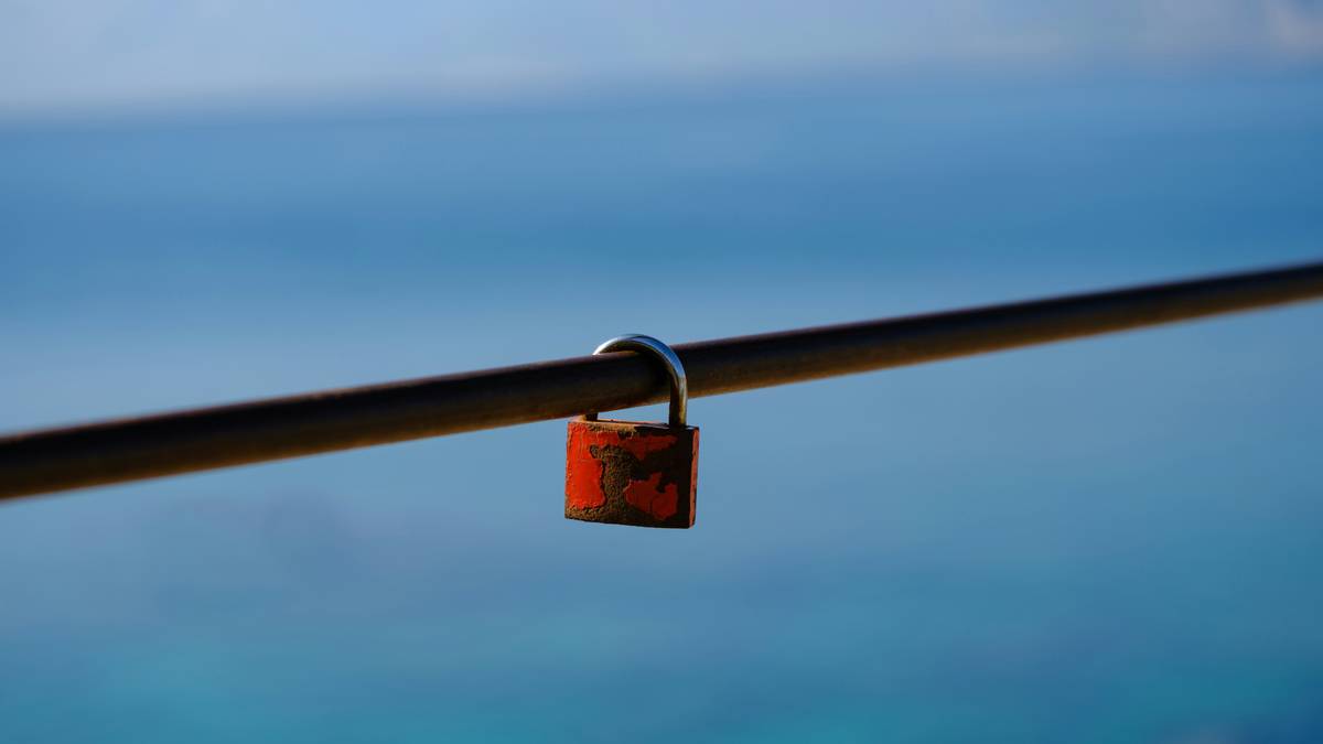 Person using a calculator on their desk surrounded by papers detailing expenses